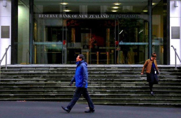 New Zealand central bank surprises by reducing stimulus, Kiwi dollar jumps