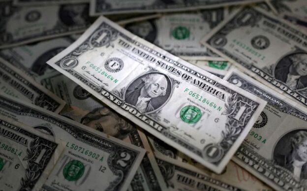 Dollar higher on safety bid as data spurs growth worries